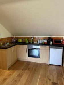 a kitchen with wooden floors and a counter top at Open plan area sleeping up to 2 adults & 2 children in Bideford