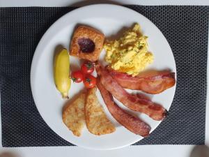 a plate of breakfast food with bacon and toast at Friendly DH Naissance Hotel by Mindrum Group in Seoul