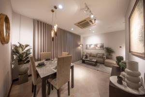 a dining room and living room with a table and chairs at Anaya Living - Colombo 03 in Colombo