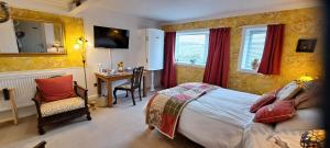 a bedroom with a bed and a desk with a chair at Salmon Landings in Strathy Point