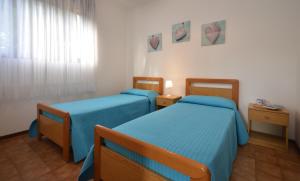 A bed or beds in a room at Appartamenti Alemagna