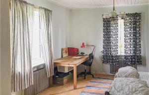 a bedroom with a desk and a bed and a window at Amazing Apartment In Boliden With Kitchen in Boliden