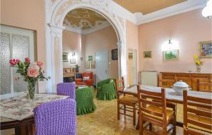 a dining room with a table and purple chairs at Nice Apartment In Camaiore With 2 Bedrooms And Wifi in Camaiore