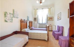 a bedroom with a bed and two purple chairs at Nice Apartment In Camaiore With 2 Bedrooms And Wifi in Camaiore