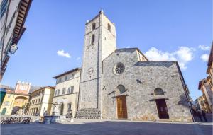an old stone church with a tower on a street at Nice Apartment In Camaiore With 2 Bedrooms And Wifi in Camaiore