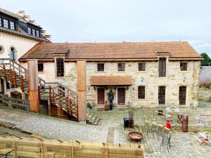 a large stone house being constructed with scaffolding at Ferienhaus NAMIBIA-LODGE im Rittergut Leppersdorf bei Dresden in Wachau