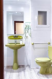 a bathroom with a green sink and a toilet at Veronica Beachfront Apartment by FESEAL in Port de Pollensa +38 photos