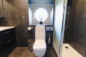 a small bathroom with a toilet and a window at Waterloo Garden residence in Waterloo