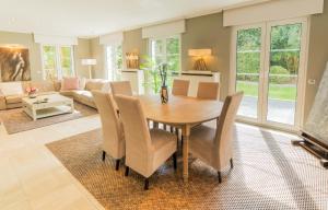 a living room with a wooden table and chairs at Waterloo Garden residence in Waterloo