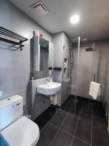 a bathroom with a toilet and a sink and a shower at SabahSuite@Jesselton Quay in Kota Kinabalu
