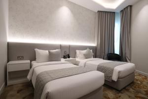 Postel nebo postele na pokoji v ubytování eStay Hotel