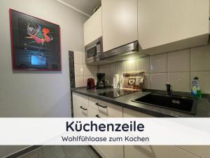 a kitchen with a sink and a counter top at Der Fuchsbau - Fewo LePetit - im sonnigen Harz - Hunde willkommen - 100m bis zum Wald - FREE WLAN in Bad Sachsa