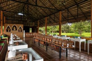 a restaurant with a long table and chairs at Ayurvie Sigiriya - Ayurvedic Retreat by Thema Collection in Sigiriya