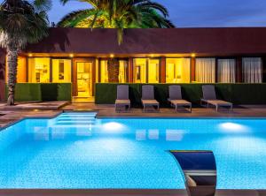 a swimming pool in front of a house at BayMari Suites Plus Florya in Istanbul