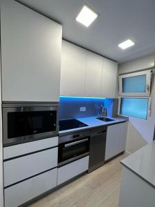 a kitchen with white cabinets and a sink at Bakio, magnificas vistas a la mar in Bakio