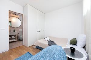 a white living room with a couch and a bed at The Grand Apartment Rovinj in Rovinj +44 photos