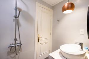 a white bathroom with a sink and a shower at Everrich Q5 - Two Bedroom in Ho Chi Minh City