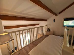 a room with a balcony with a bed and a lamp at Maison Saint-Jean-de-Monts, 3 pièces, 5 personnes - FR-1-224C-125 in Saint-Jean-de-Monts