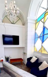 a living room with a chandelier and a window at Villa La Terrazza Suites in Sorrento