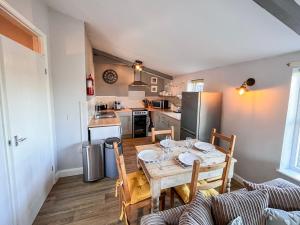 a kitchen and dining room with a table and chairs at Blueberry Cottage in Bedfield