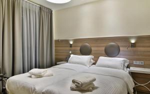 A bed or beds in a room at Z Inn Ioannina