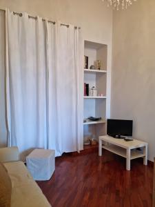 a living room with a couch and a table with a television at La terrazza di nonno Ciccio in Monopoli