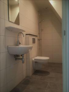 a bathroom with a sink and a toilet at Private apartment - Green Heart center NL in Woerden