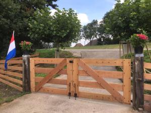 una puerta de madera con una bandera encima en Private apartment - Green Heart center NL, en Woerden 6 fotos más