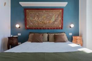 a bedroom with a bed with a painting on the wall at Casa del Toro allo Stadio Filadelfia by Wonderful Italy in Turin