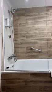 a shower in a bathroom with a white tub at Hotel Albatros in Gandía