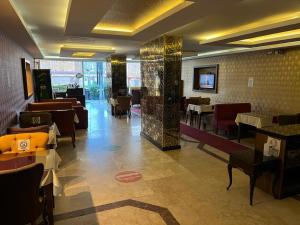 a restaurant with tables and chairs in a room at Metro Otel in İzmir