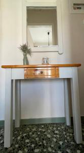 a bathroom vanity with a sink and a mirror at Hotel Angela in Asprovalta