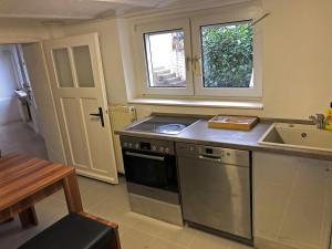 a kitchen with a sink and a stove top oven at Ruhige Monteurwohnung in Werder in Plötzin