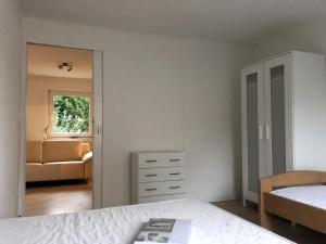 a bedroom with a bed and a dresser and a mirror at Ruhige Monteurwohnung in Werder in Plötzin