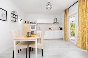 une cuisine et une salle à manger avec une table et des chaises dans l'établissement Apartman Ponte Mohito, à Punat 10 autres photos