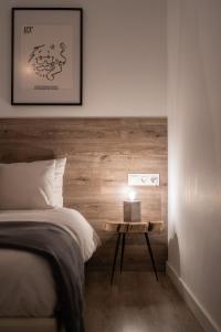 a bedroom with a bed and a side table at Plaka With Acropolis Rooftop View Access in Athens