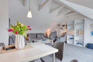 a living room with a white table and chairs at Haus Kleemann in Norderney