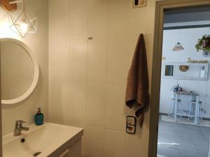 a bathroom with a sink and a mirror at Arte y natura en la playa de Eucaliptus in L'Eucaliptus