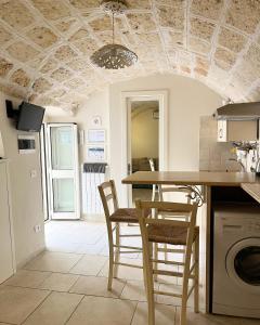 a kitchen with a table and chairs in a room at Donna Nina in Monopoli