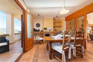 a kitchen and dining room with a table and chairs at Maia in Moscari