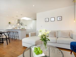 a living room with a couch and a table with fruit on it at Eugene Sands in Paignton