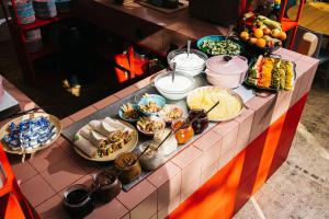 a buffet with many different types of food on a counter at The Green Elephant Hostel & Spa in Maastricht