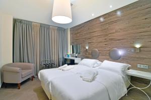 A bed or beds in a room at Z Inn Ioannina