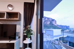 a room with a window with a view of a mountain at A402-Silk Condo Aonang-Sea view-5 mins walk to beach in Ao Nang Beach
