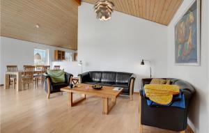 a living room with black leather furniture and a table at Amazing Home In Videbk With Wifi in Videbæk