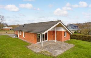 a red brick house with a black roof at Amazing Home In Videbk With Wifi in Videbæk