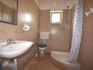 a bathroom with a sink and a toilet and a shower at Apartment in holiday home with pool spacious garden with grill airco and wifi in Banjole