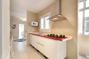 una cocina con fregadero y una barra con un tablero de ajedrez. en Apartment Capuchinos, en Málaga