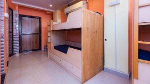 a room with wooden bunk beds in a room at HOTEL AVISHA Residency in Marmagao