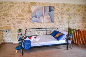 a bedroom with a bed with two paintings on the wall at Villa Anastasia Luxe with Top WiFi, BBQ & Amazing Views in Kissamos